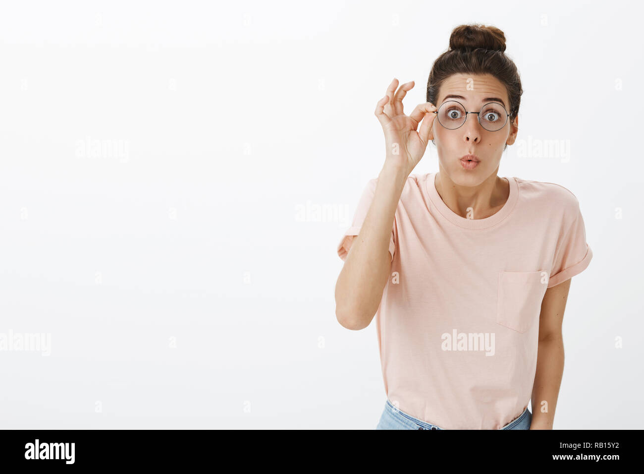 Girl putting on glasses realising how world look without blur folding