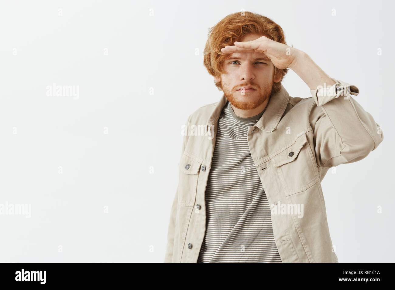 Trying to see on distance. Portrait of goodlooking young traveler and