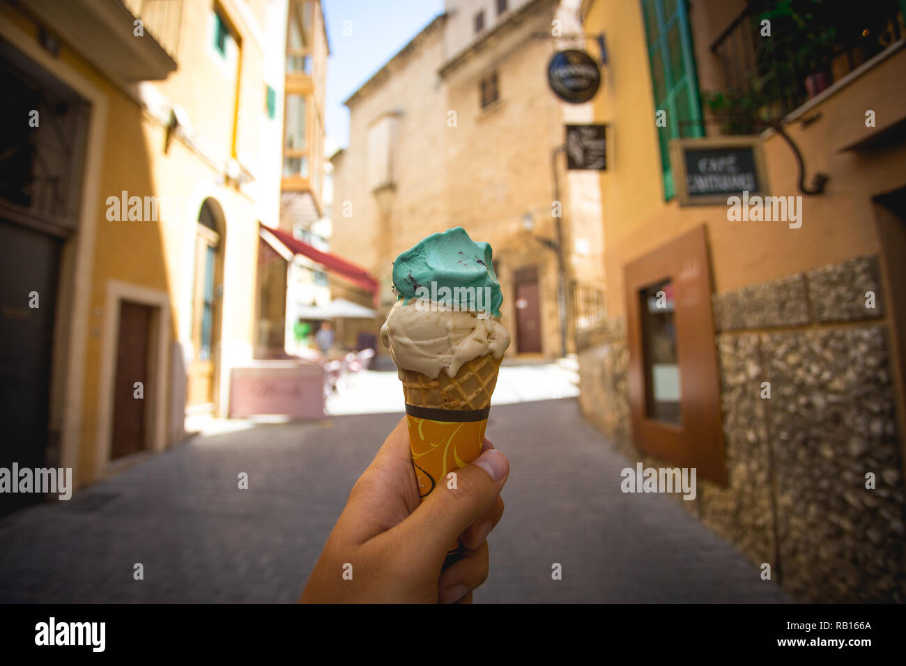 Ice Cream cone in a hand in the street of Palma de Mallorca, Spain