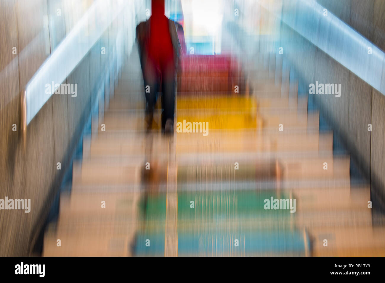 person walking on a colored stairway - abstract image Stock Photo