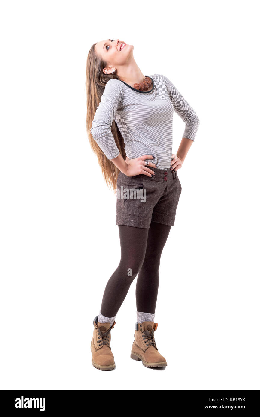 Side view of cheerful relaxed smiling hipster woman with head back looking up. Full body isolated on white background. Stock Photo