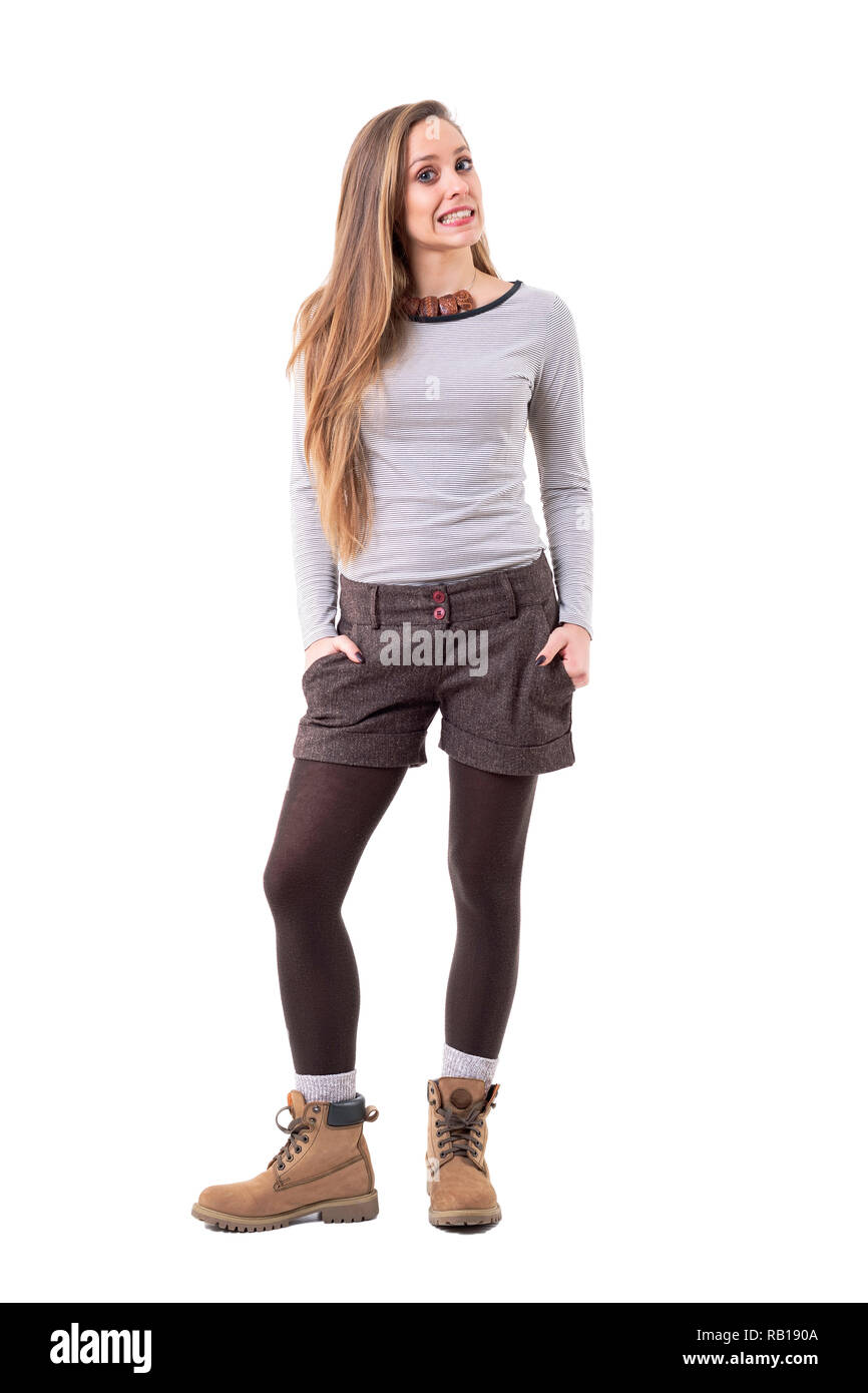 Cool funny cute hipster girl in authentic second hand clothes grimacing and having fun. Full body isolated on white background. Stock Photo