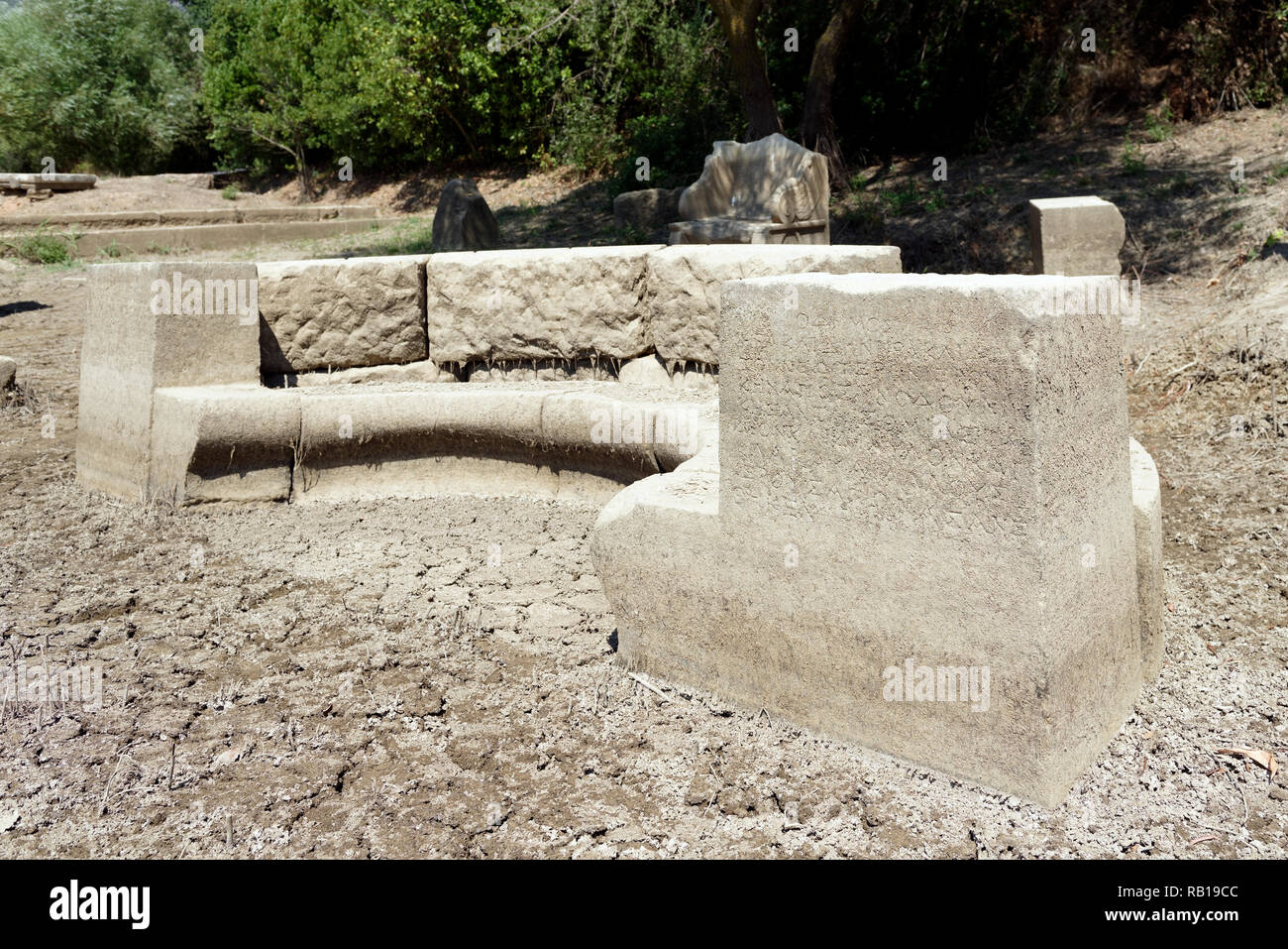 Ancient Greek inscriptions on a Exedra, a semicircular recess where visitors sat and conversed, ancient Greek sanctuary of Apollo of Claros, Turkey. Stock Photo