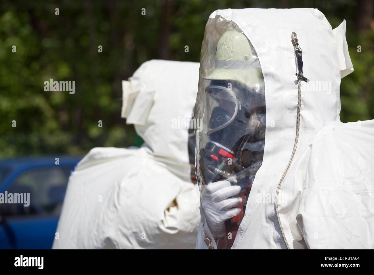 Two unrecognizable men in protective gear. The inflatable gear protects against contamination with radioactive particles, against Alpha radiation and  Stock Photo