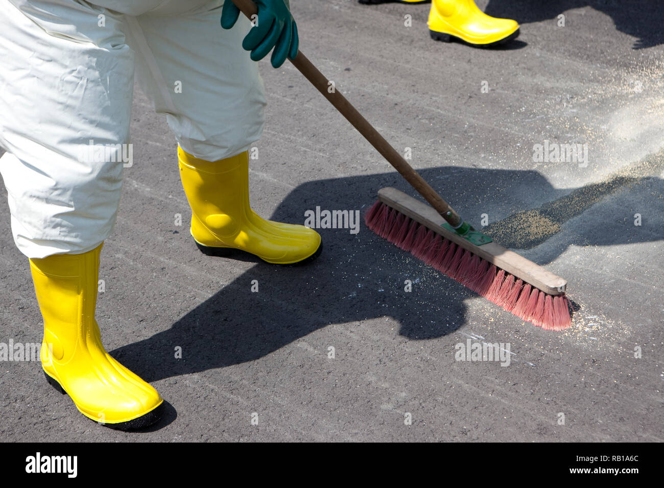 Men in protective gear cleaning up after chemical accident. The inflatable gear also protects against contamination with radioactive particles, agains Stock Photo