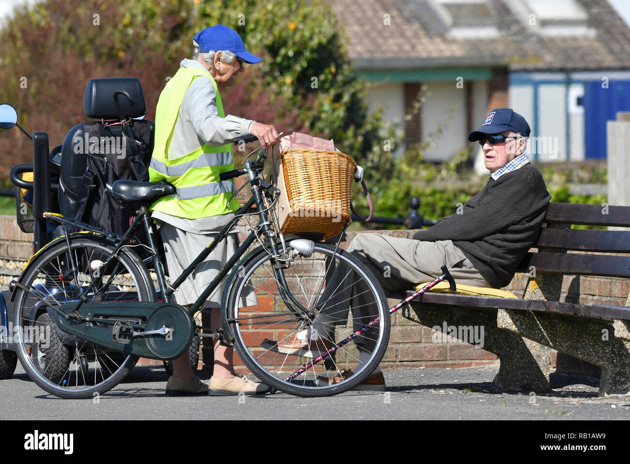 A couple of people meet and have a chat on a promenade in the UK. Stock Photo