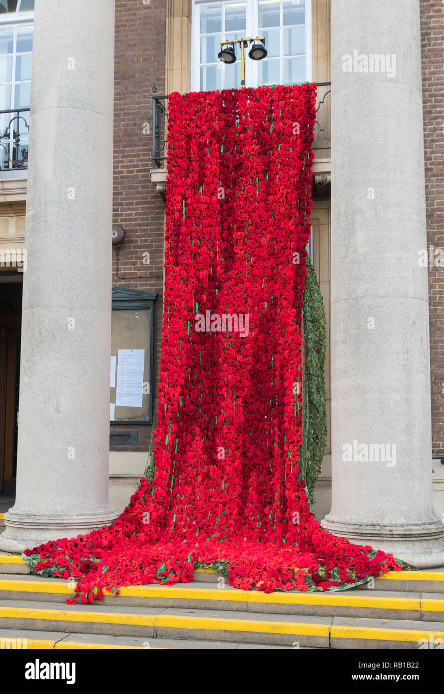 Display of poppies draped over balconies outside Worthing Town Hall for Remembrance Day 2018 in Worthing, West Sussex, England, UK. Stock Photo