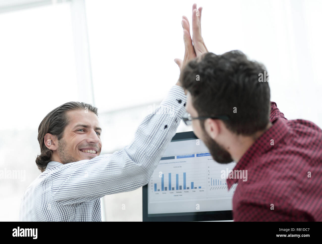 members of the business team giving each other a high five Stock Photo ...
