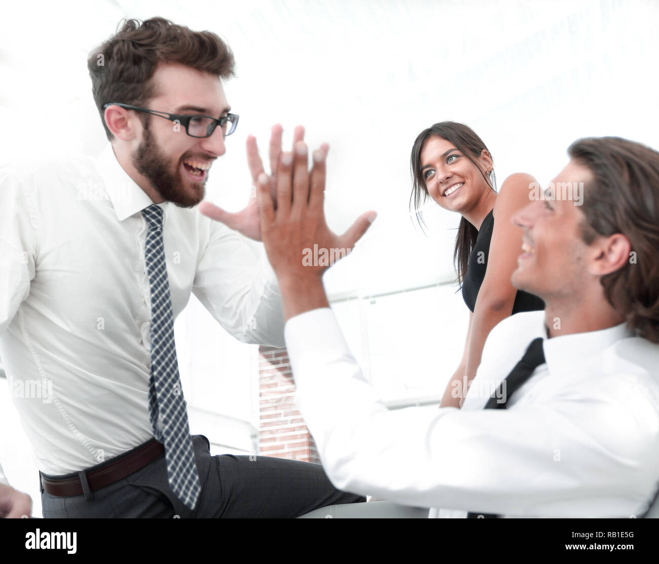 business colleagues giving each other high five Stock Photo - Alamy