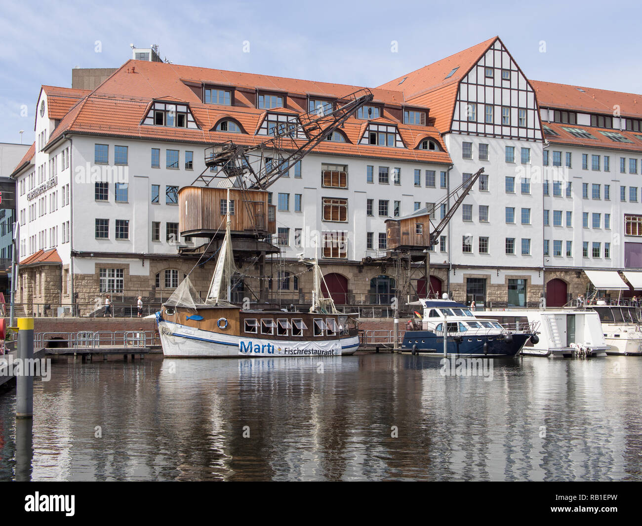 BERLIN, GERMANY - JUNE 21, 2017: Old Wooden Cranes And Boats In Tempelhofer Hafen, Meaning Harbor of Tempelhof In German Language, In Berlin Stock Photo