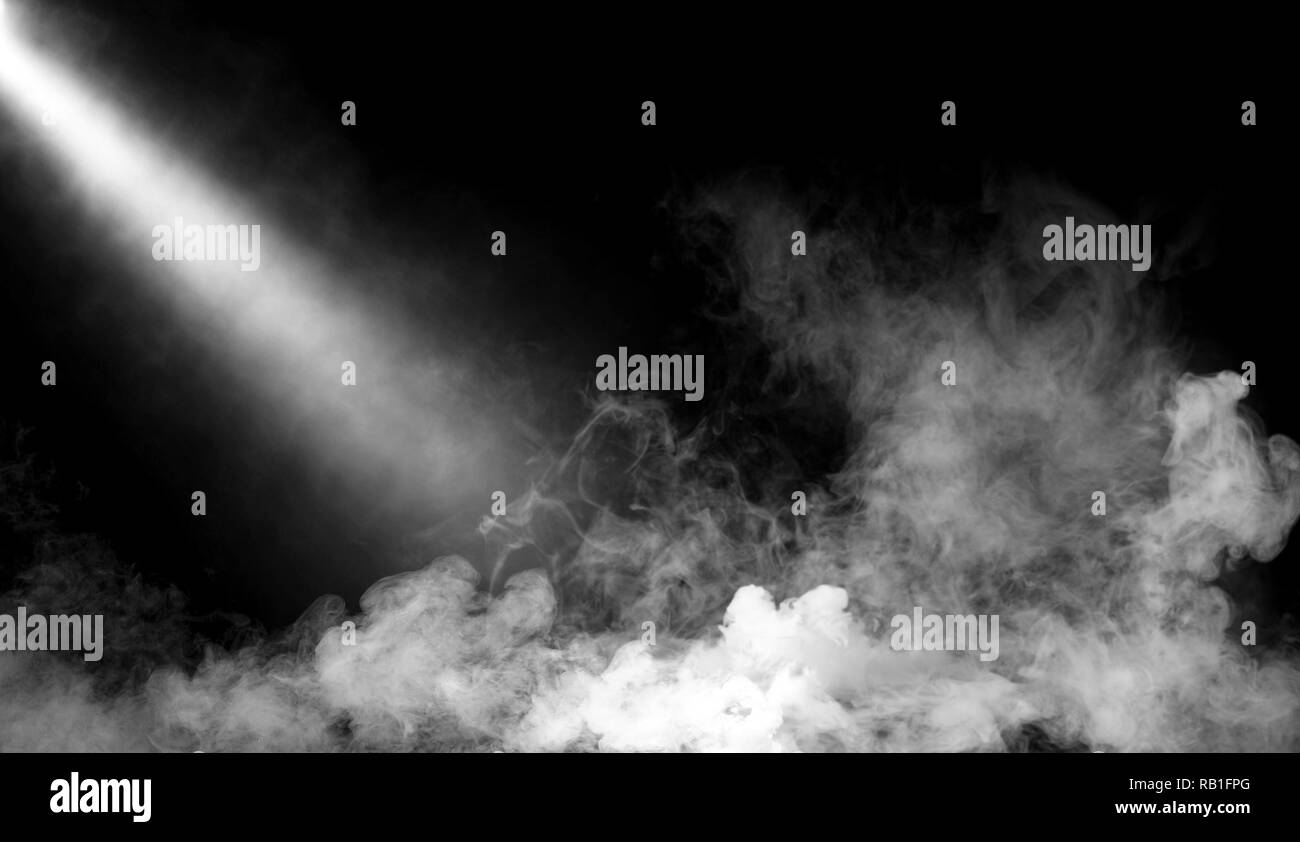 Spotlight with smoke mist effect on isolated black background Stock Photo