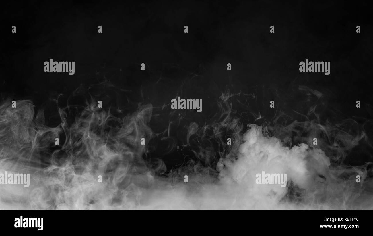 Rolling billows of smoke mist clouds from dry ice across the bottom light . Fog on Floor isolated background black texture Stock Photo