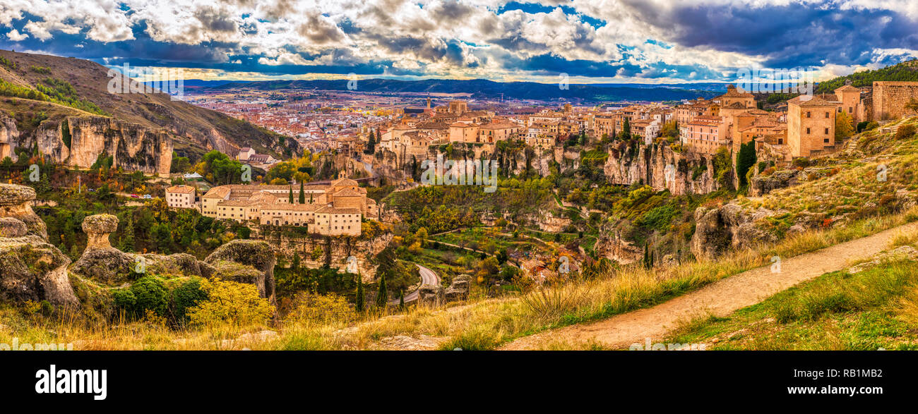 A panoramic daytime view of Cuenca Spain from the top of the mountainous area where the castle is situated with clouds and greenery along with the old Stock Photo