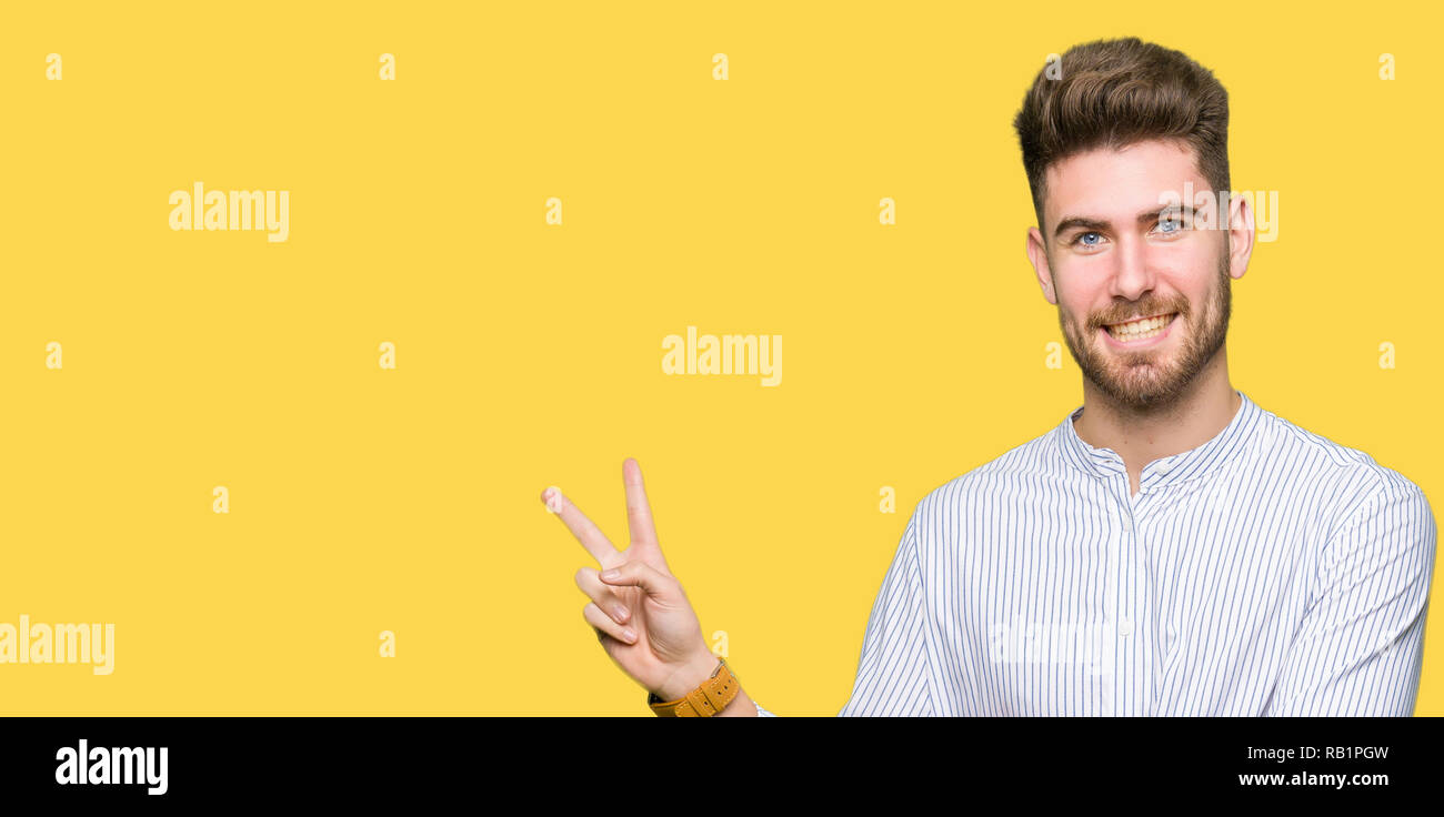 confident handsome caucasian man winking and smiling at camera on blue studio background stock photo alamy confident handsome caucasian man winking and smiling at camera on blue studio background stock photo alamy