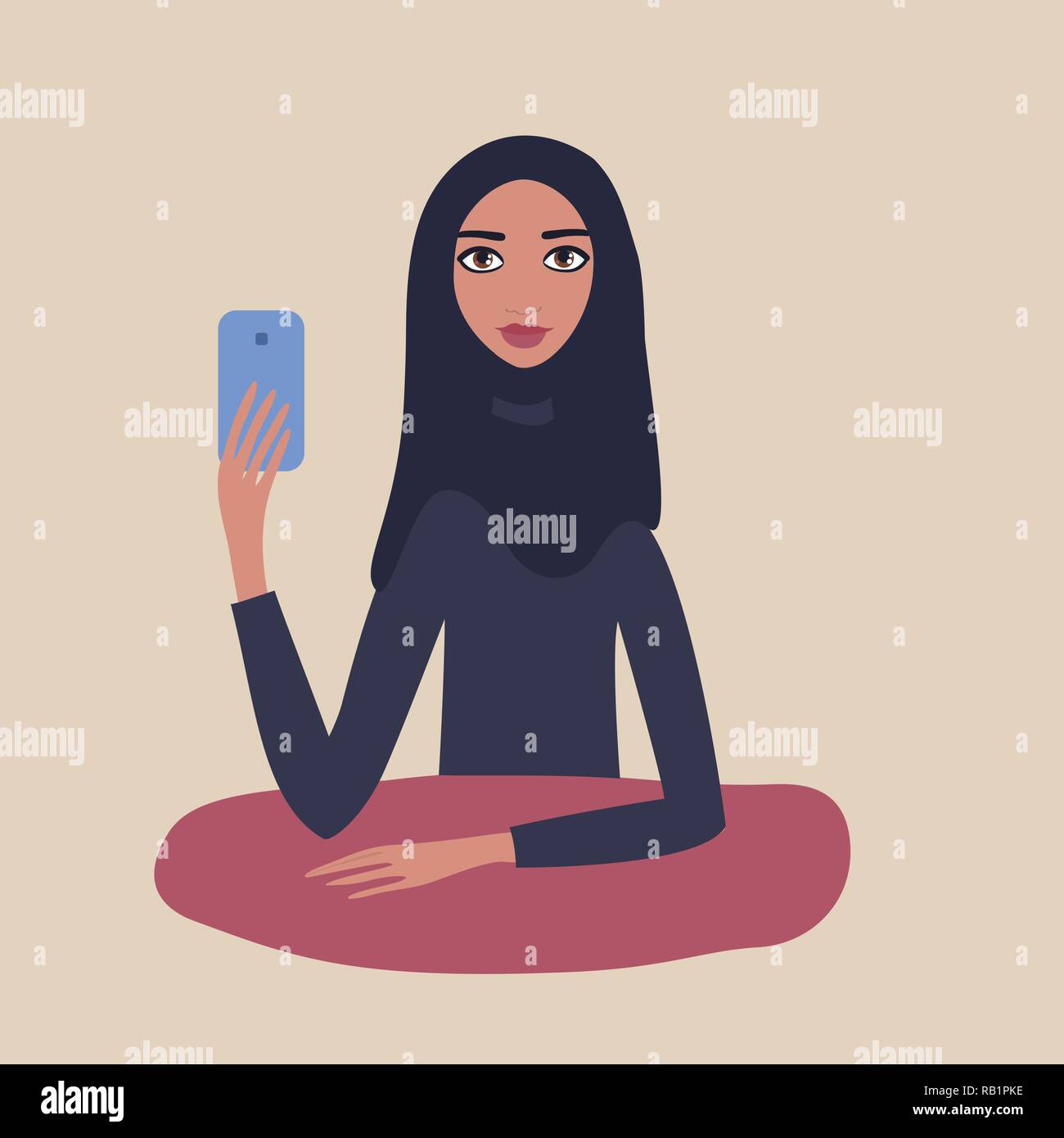 Beautiful Muslim woman wearing hijab holding mobile phone in her hand ...