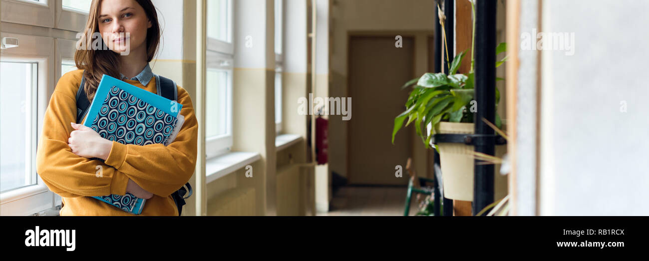Window Alone Student Young attractive female high school student standing by the window in ...