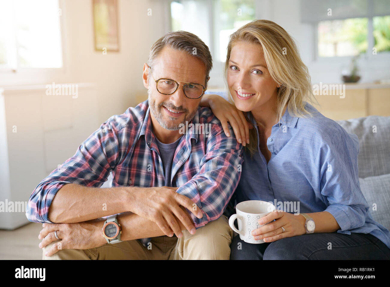 Portrait of mature couple relaxing at home Stock Photo - Alamy