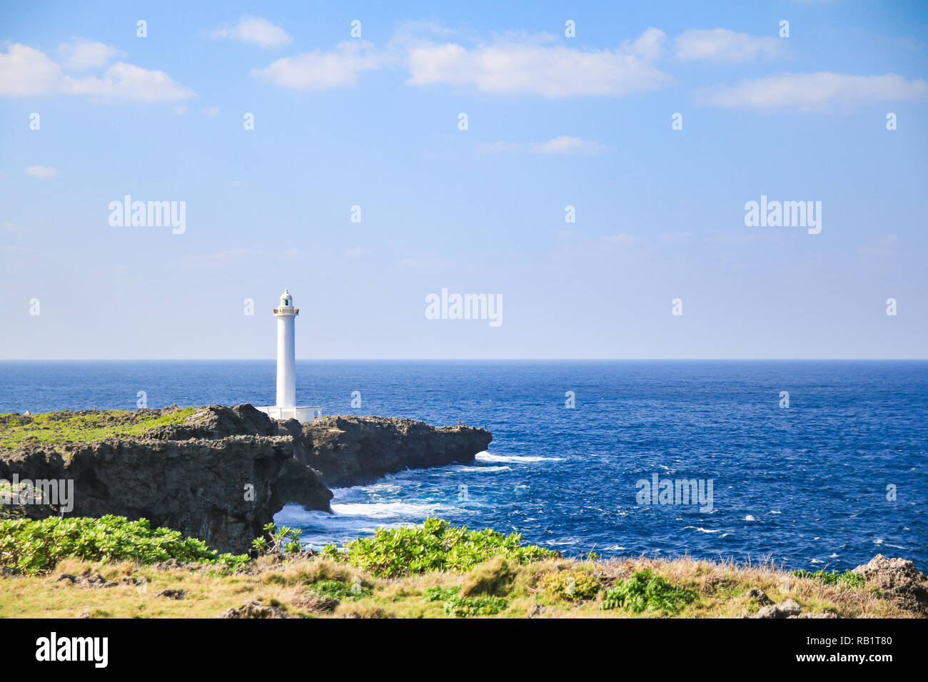 white lighthouse in cape zanpa in Japan with blue sea and sky Stock Photo
