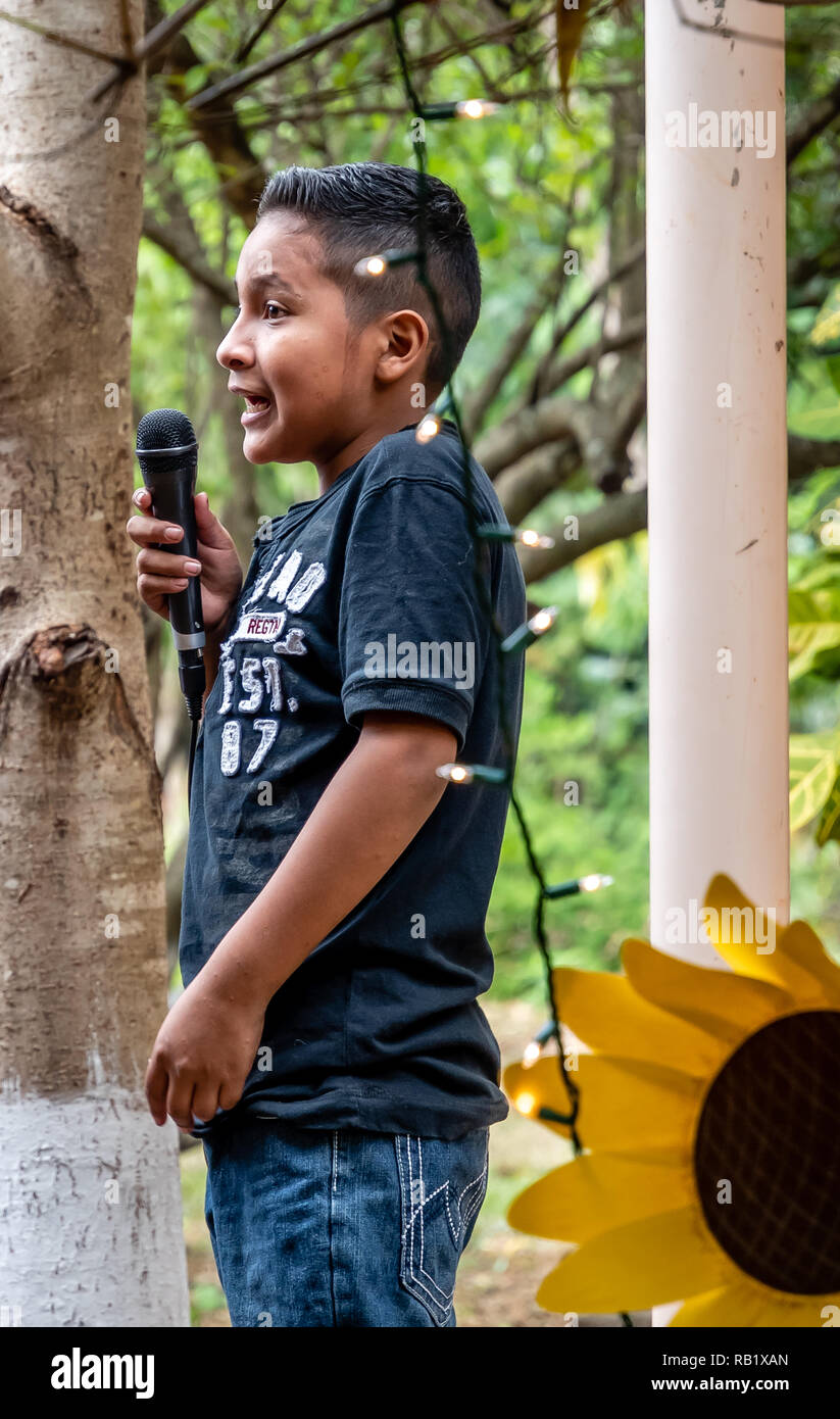 latin child with microphone at party in Guatemala Stock Photo Alamy