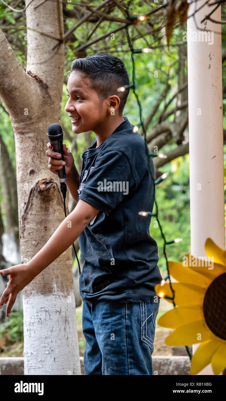 latin child with microphone at party in Guatemala Stock Photo Alamy
