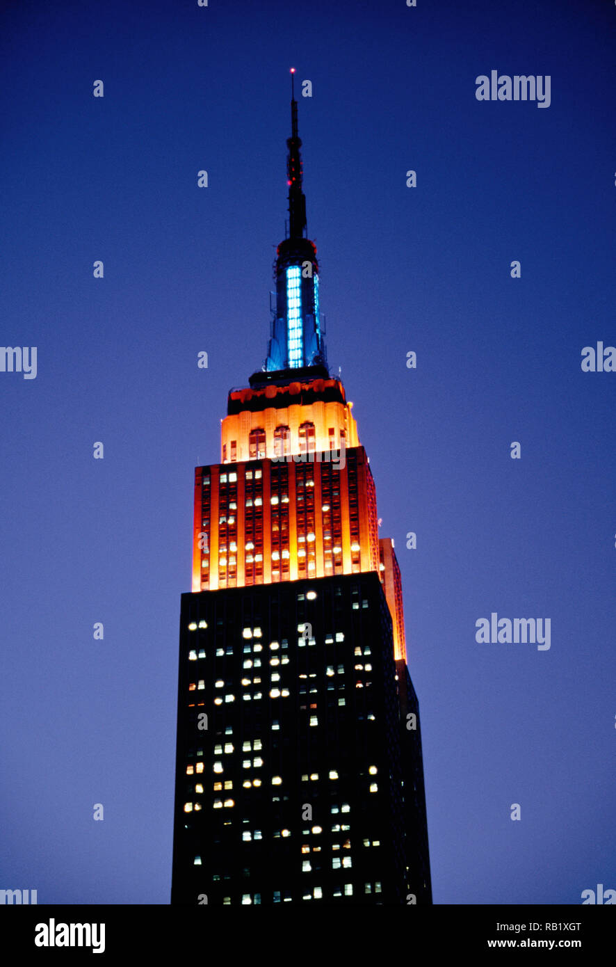 Empire Statue Building Lit in Blue and Orange , Dusk, NYC, USA Stock Photo