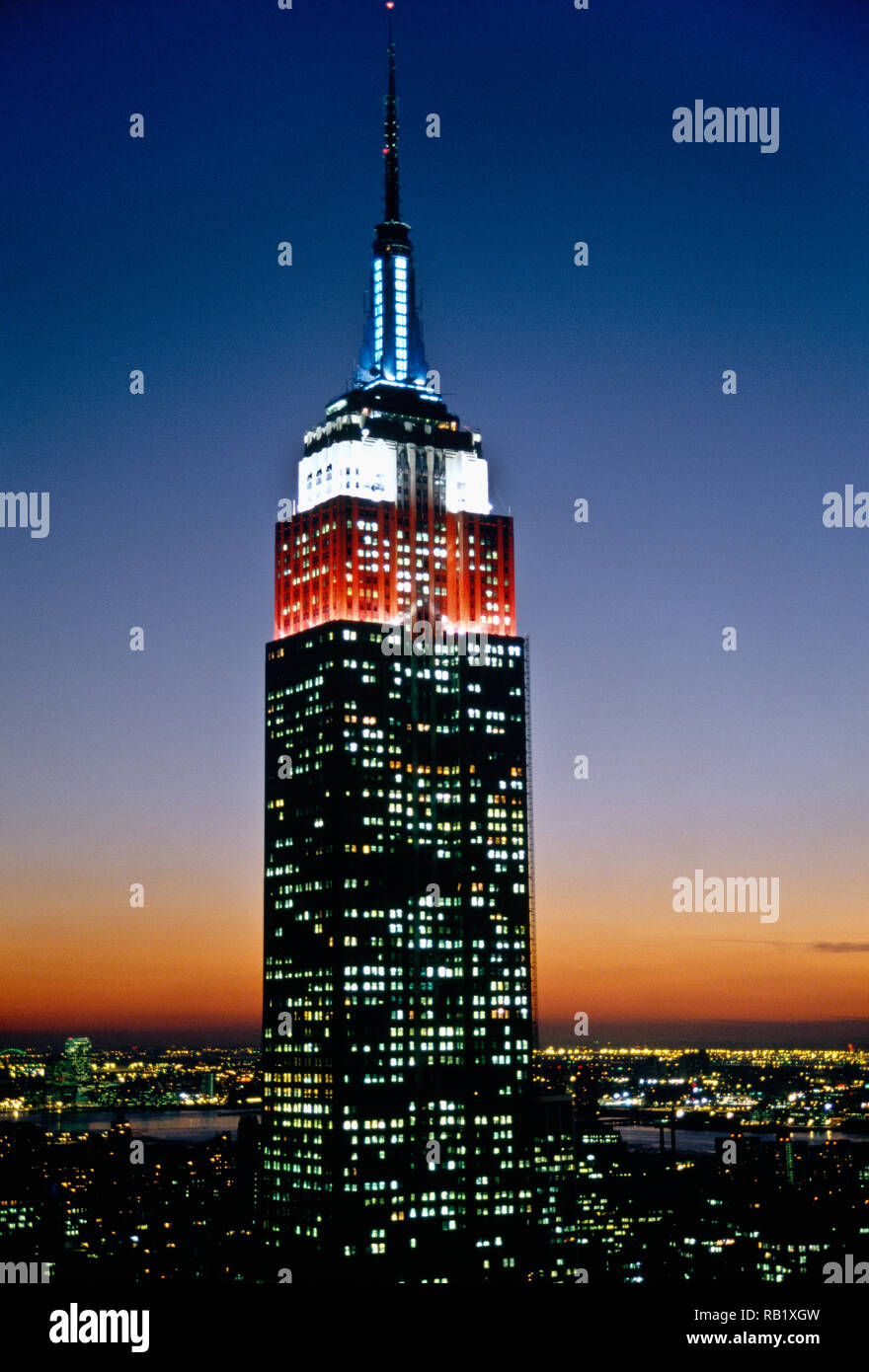 Empire Statue Building Lit in Red, White and Blue, Dusk, NYC, USA Stock Photo