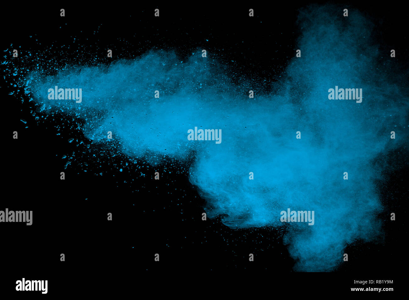 Blue powder explode cloud on black background. Launched blue dust particles splash on  background. Stock Photo