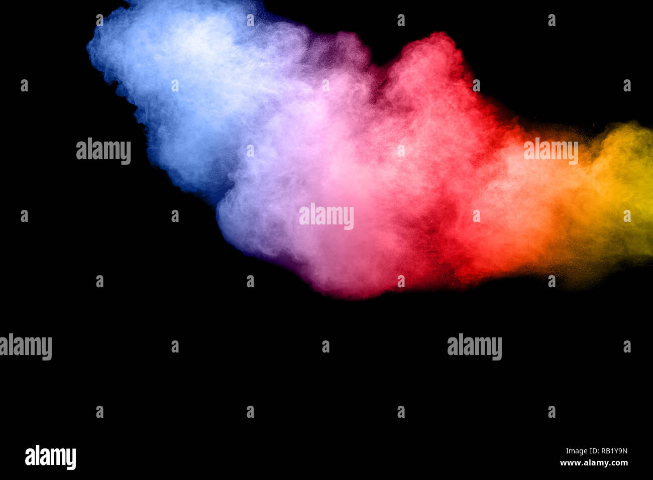 Abstract color powder explosion on black background.Freeze motion of dust splash. Painted Holi in festival. Stock Photo