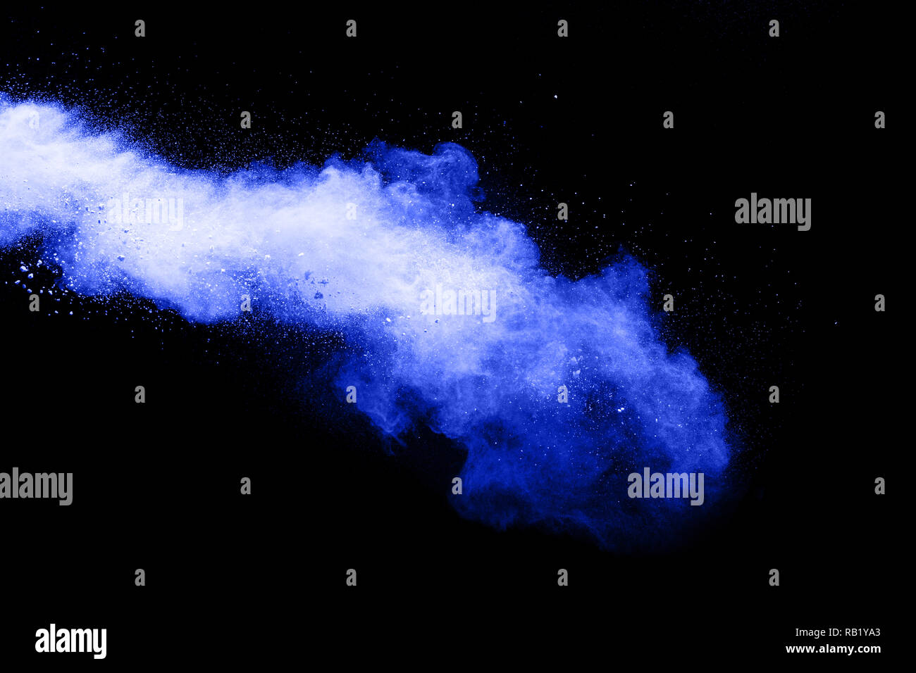 Blue powder explode cloud on black background. Launched blue dust particles splash on  background. Stock Photo