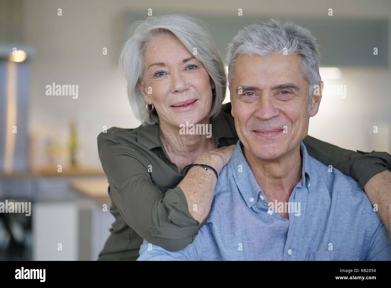 Portrait of loving senior couple in modern home Stock Photo - Alamy