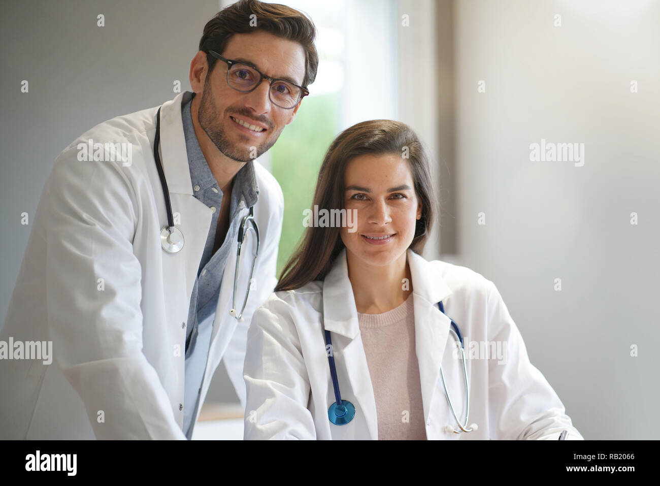 Young doctors in lab coats smiling Stock Photo