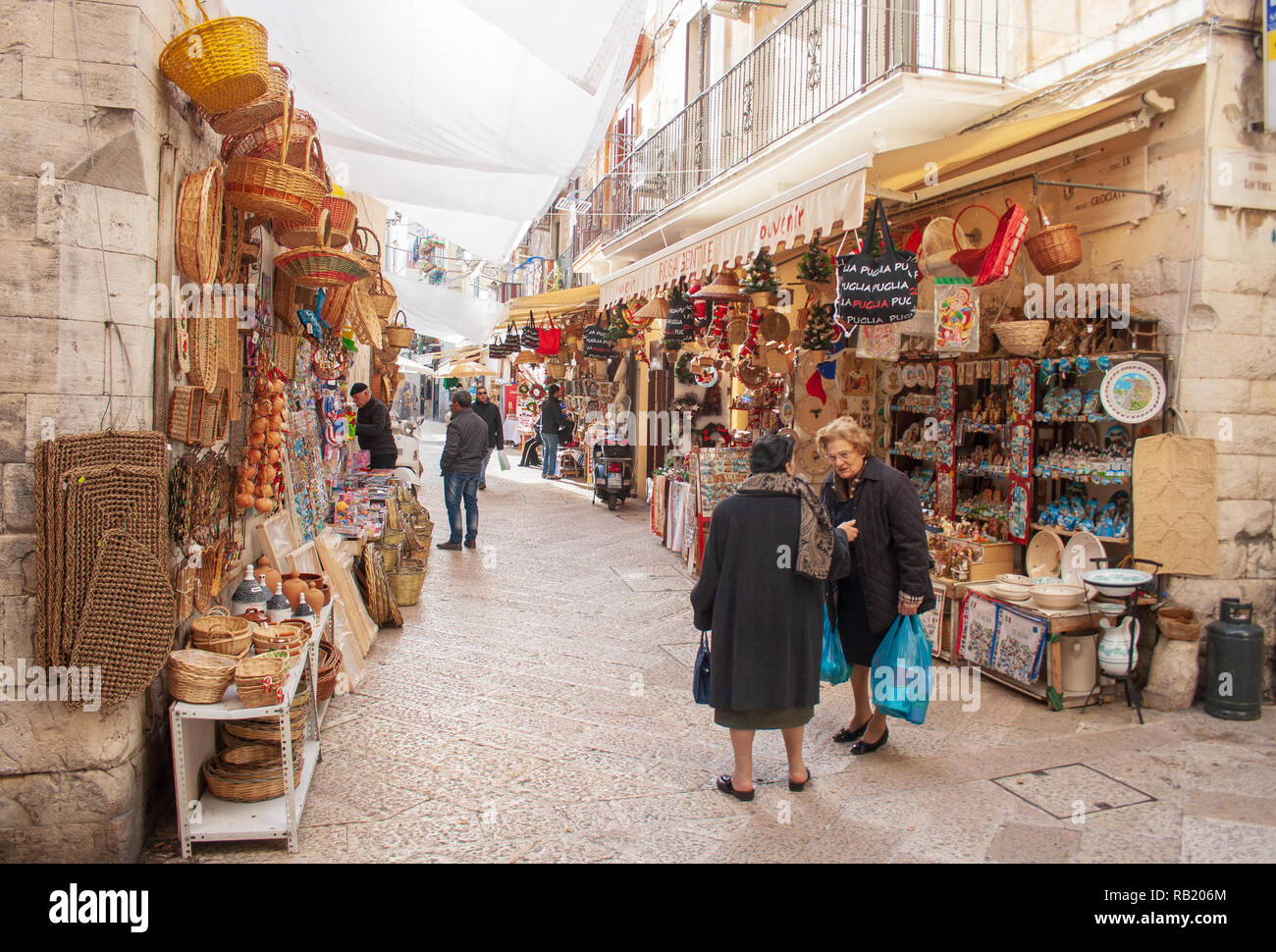 View of a narrow street in  Bari, Puglia, Italy, Bari vecchia, traditional open market shops with souvenir for tourists Stock Photo