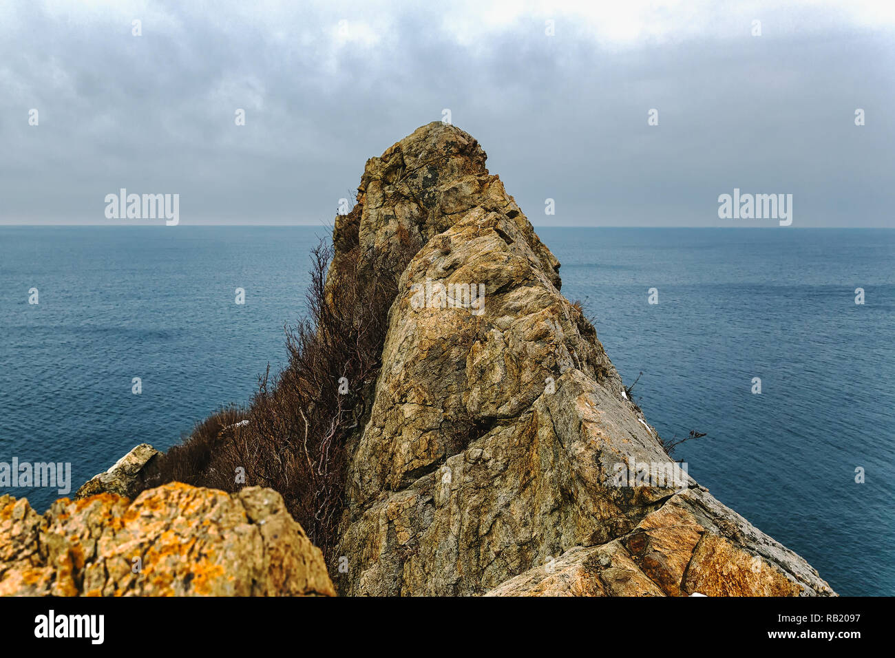 High rocky cliff peak and sea view Stock Photo