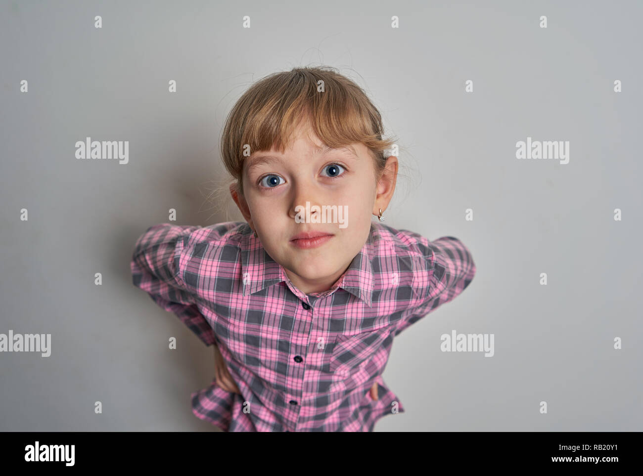 little girl grimacing on white background Stock Photo