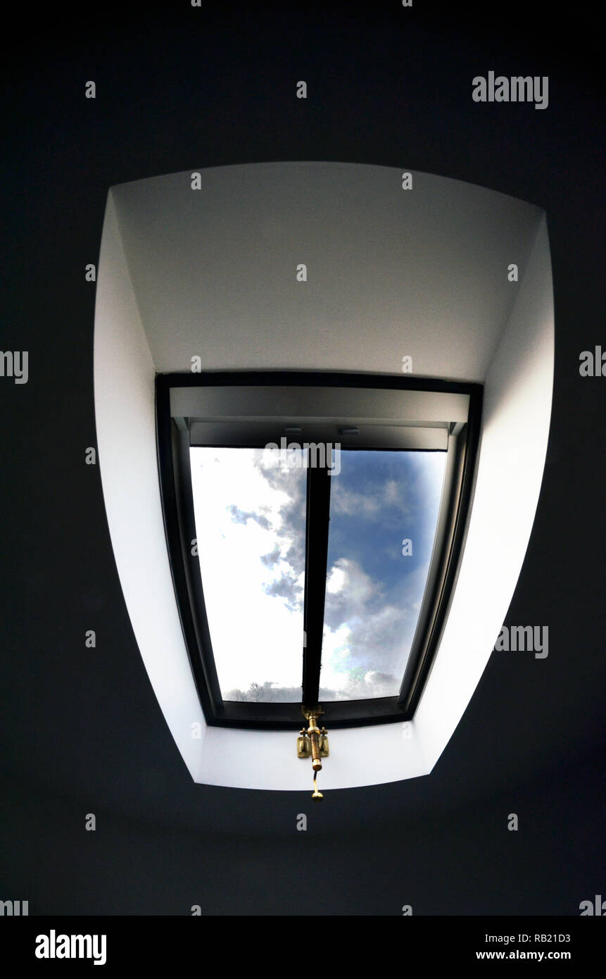 velux style opening skylight  in bedroom roof Stock Photo