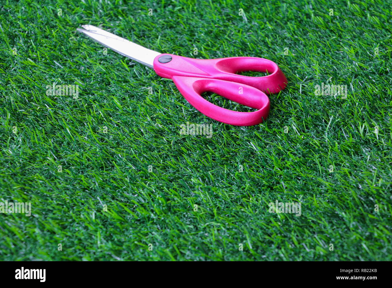 scissor red on artificial grass background Stock Photo Alamy