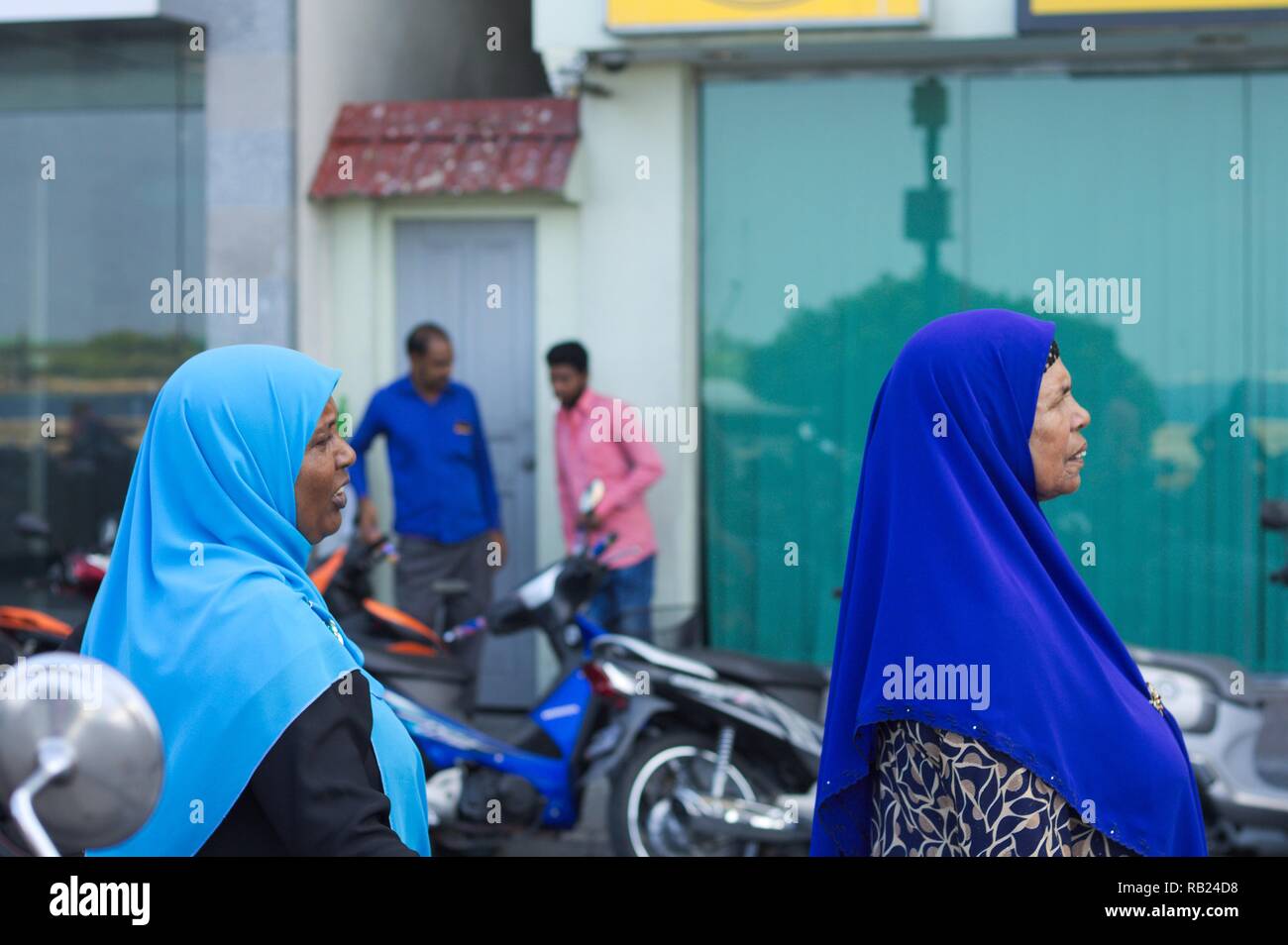 Male, Maldives - 20 December 2018: Two maldivian women with a blue veil (muslim religion) Stock Photo