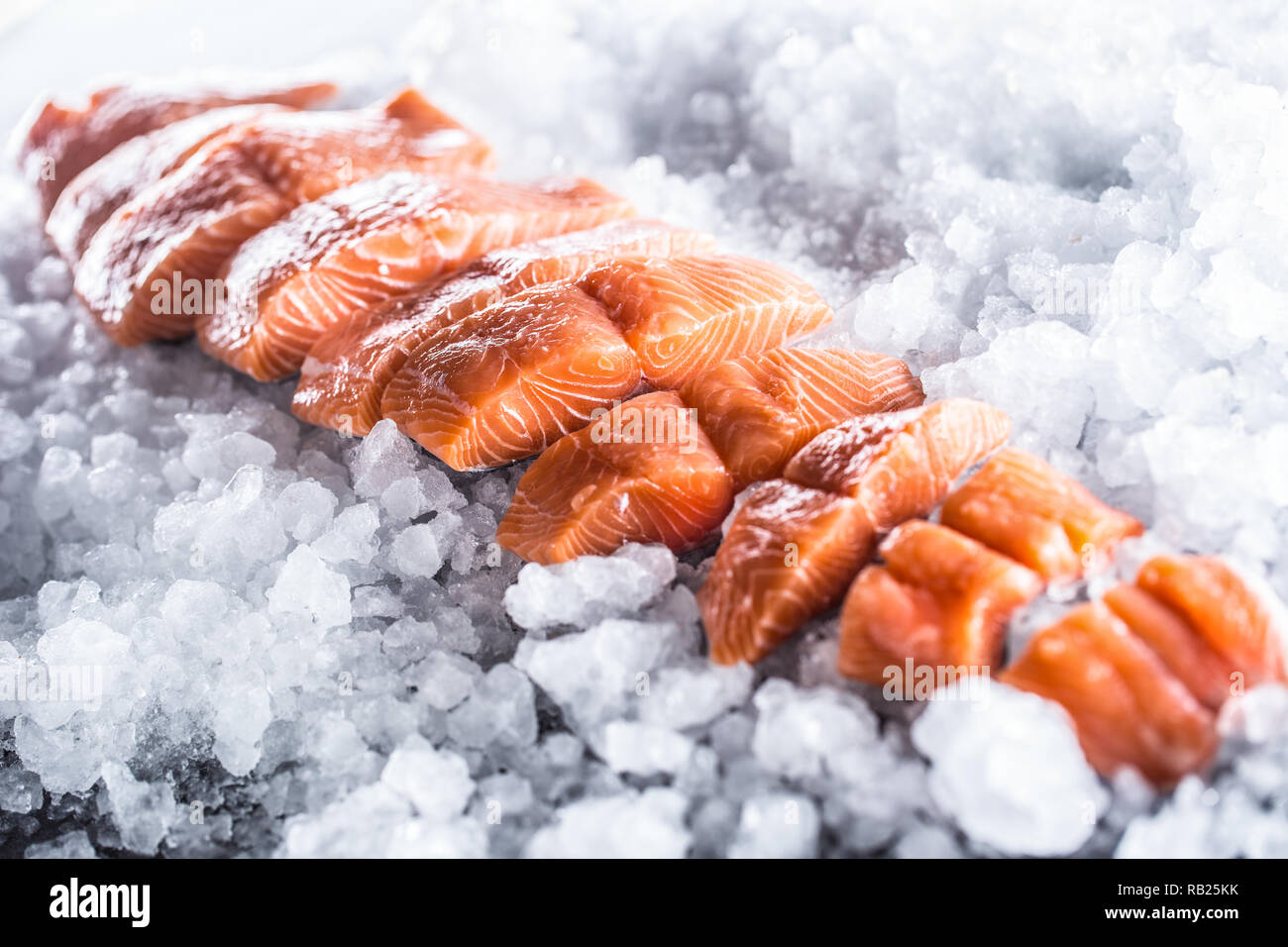 Salmon fillets portioned on ice and empty kitchen board Stock Photo - Alamy