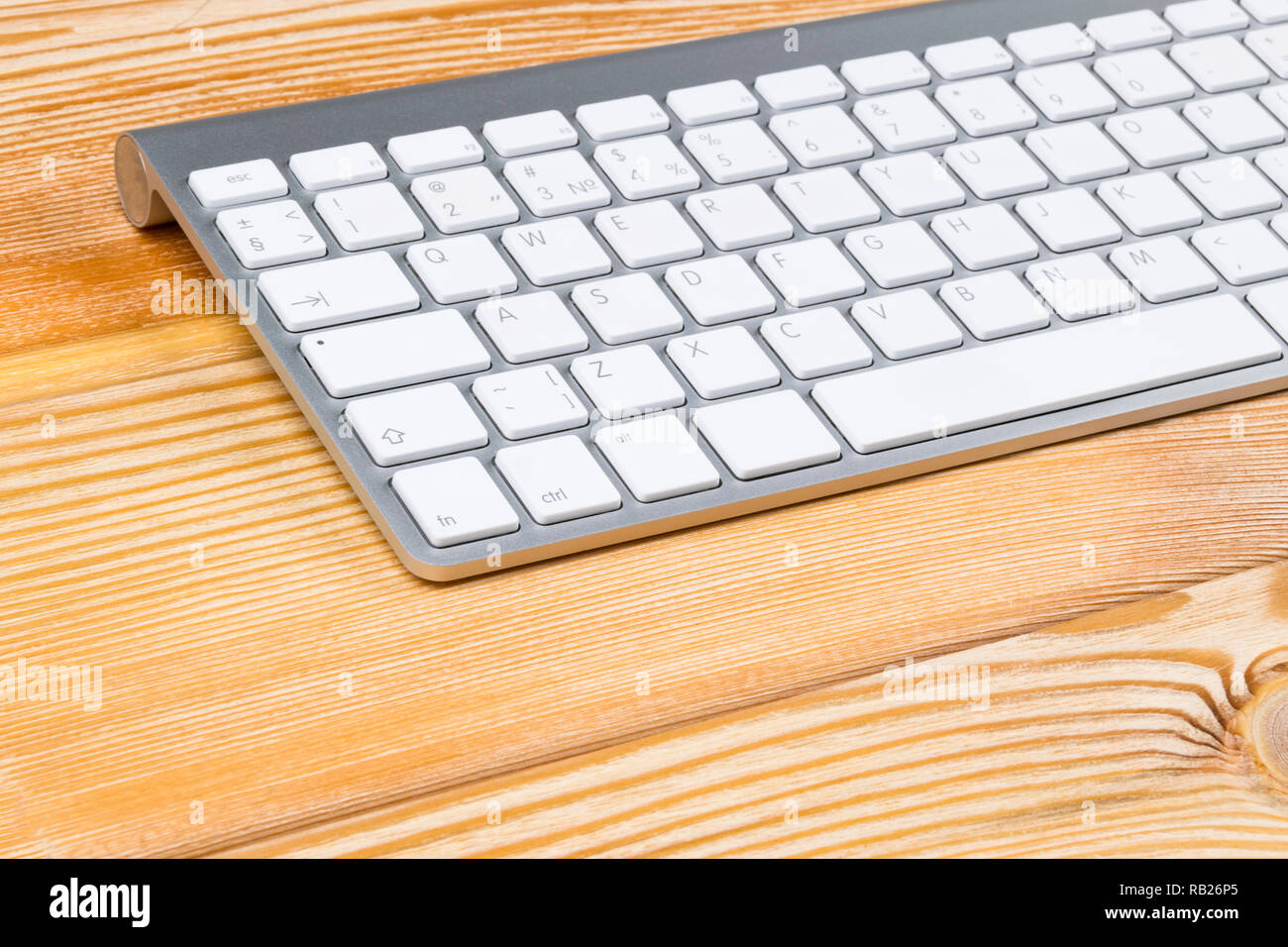 Business workplace with wireless keyboard on old natural wooden table ...