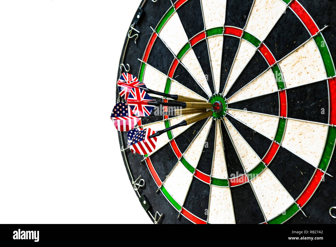 Metal darts have hit the red bullseye on a dart board. Darts Game. Darts arrow in the target center darts in bull's eye close up isolatedon white back Stock Photo