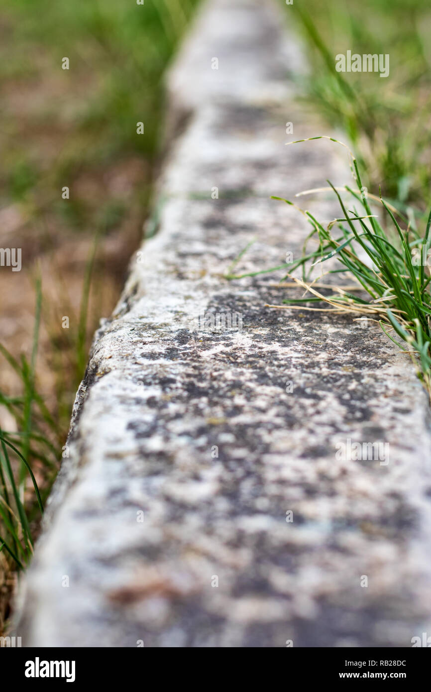 Boundary line in lawn made of limestone Stock Photo