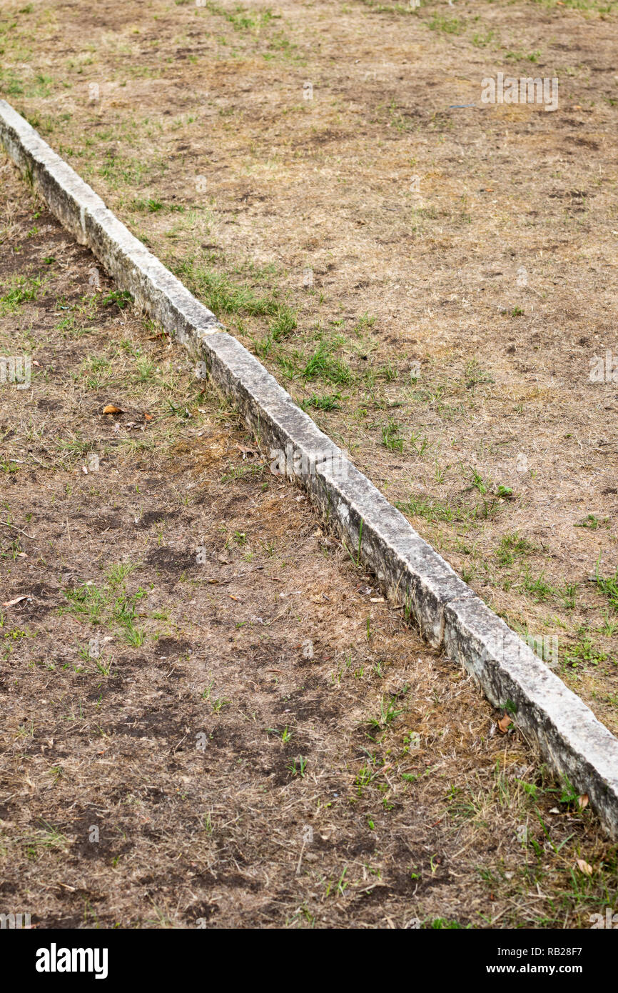 Boundary line in lawn made of limestone Stock Photo