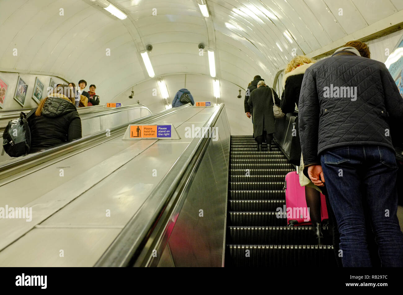 tube escalator in london tube stations with people Stock Photo