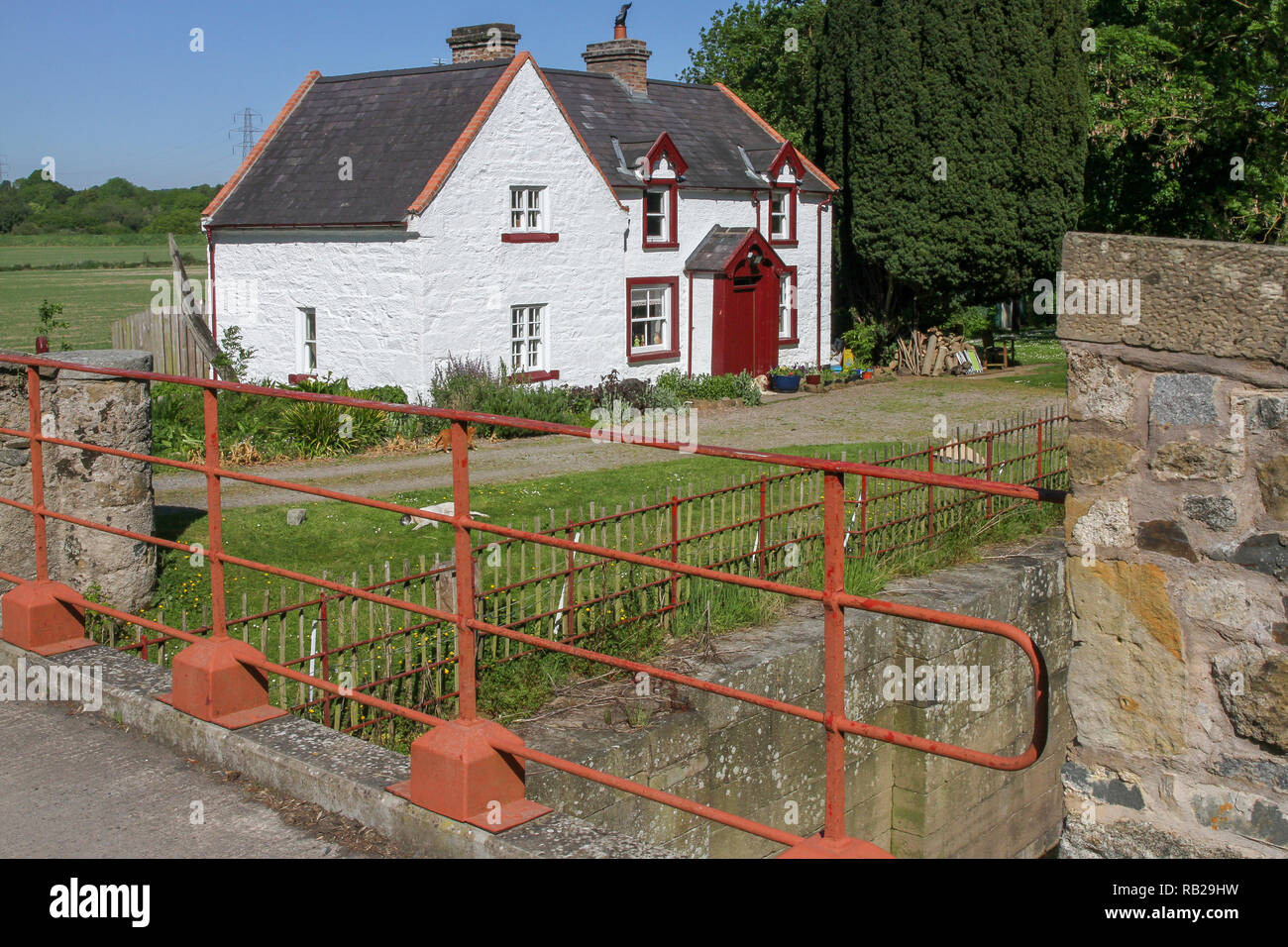 Whitewashed canal lockhouse UK. Moneypenny's Lock and Moneypenny's Lockhouse on the former Newry Canal in Northern Ireland. Stock Photo