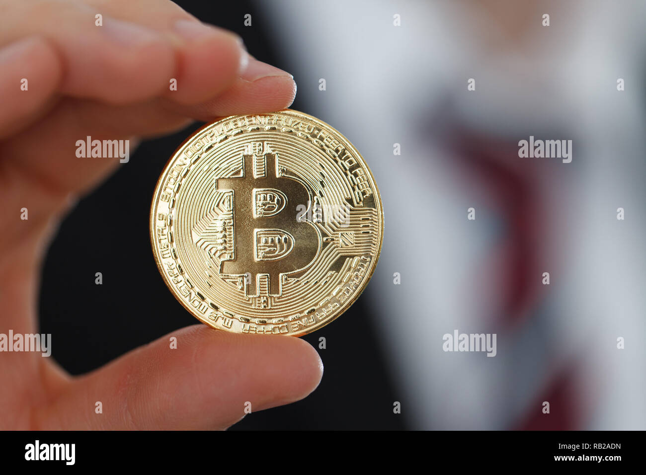 Businessman showing Gold Bitcoin Stock Photo