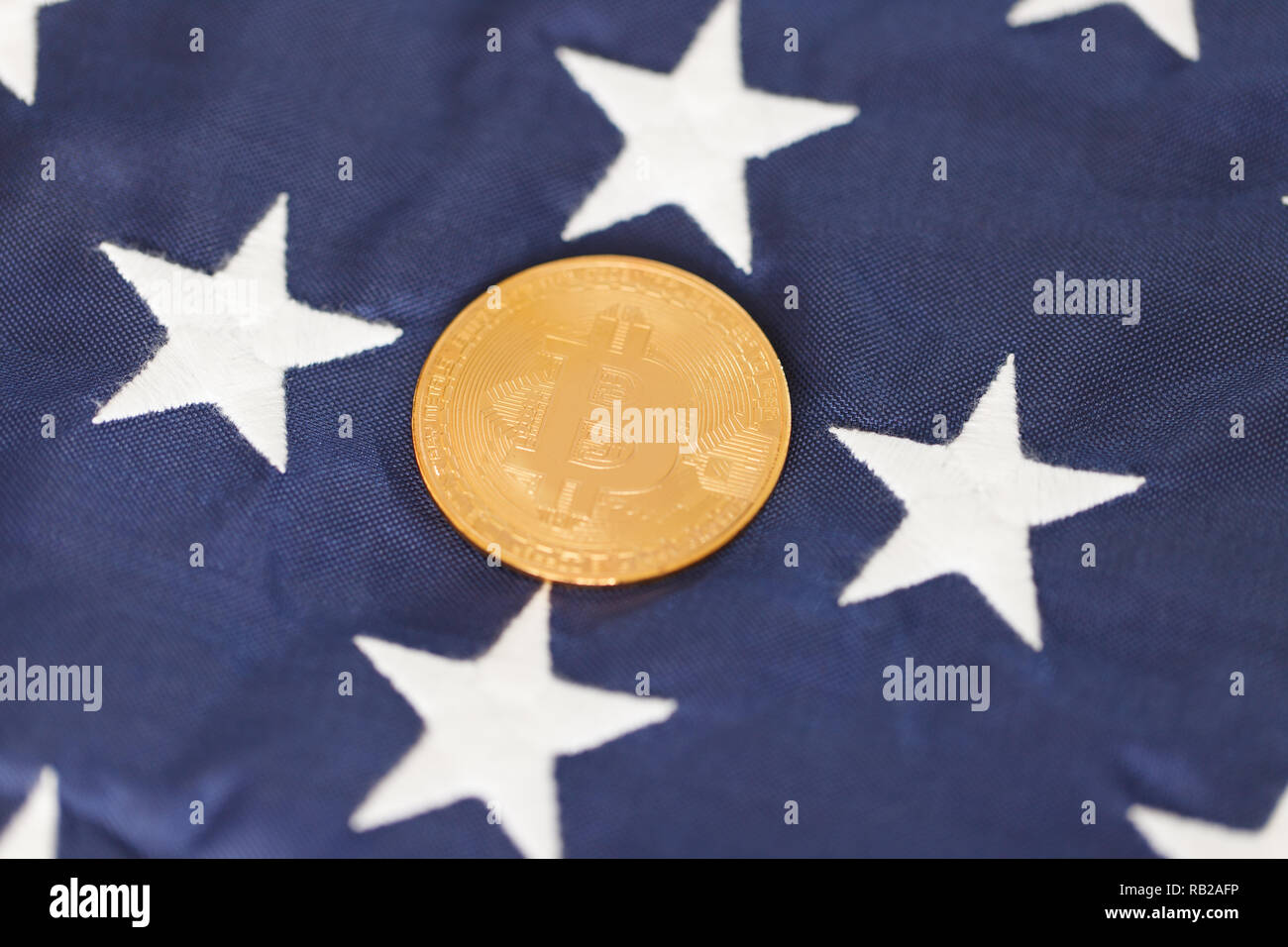 Golden Bitcoin on the flag of USA Stock Photo