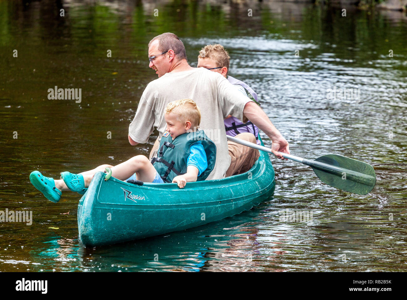 Active family canoeing river, child in canoe,  summer adventure for children on holiday, Czech Republic Stock Photo