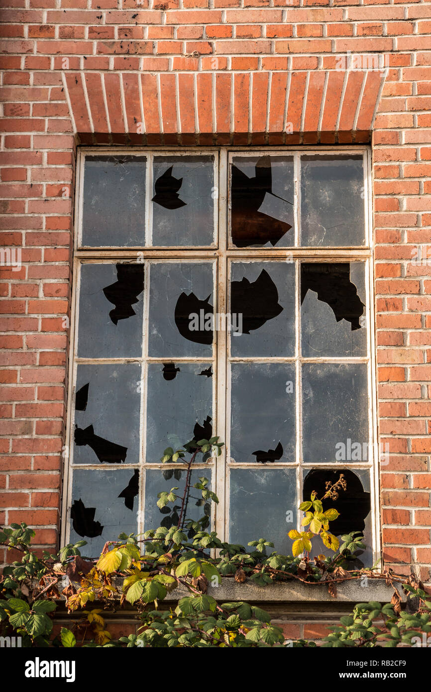 Old destroyed brick house ruin with broken windows Stock Photo