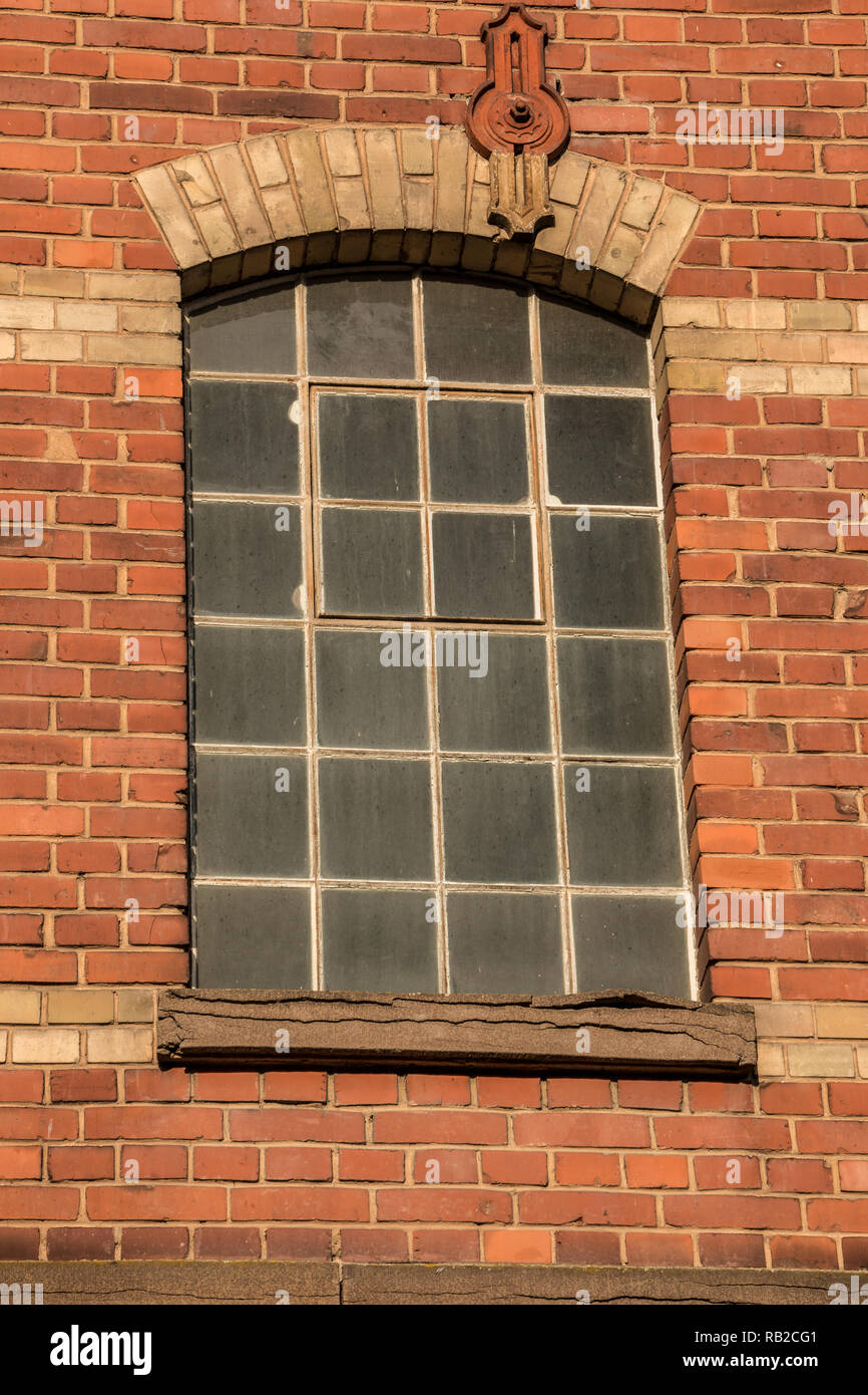 Old empty brick house factory with dark windows Stock Photo
