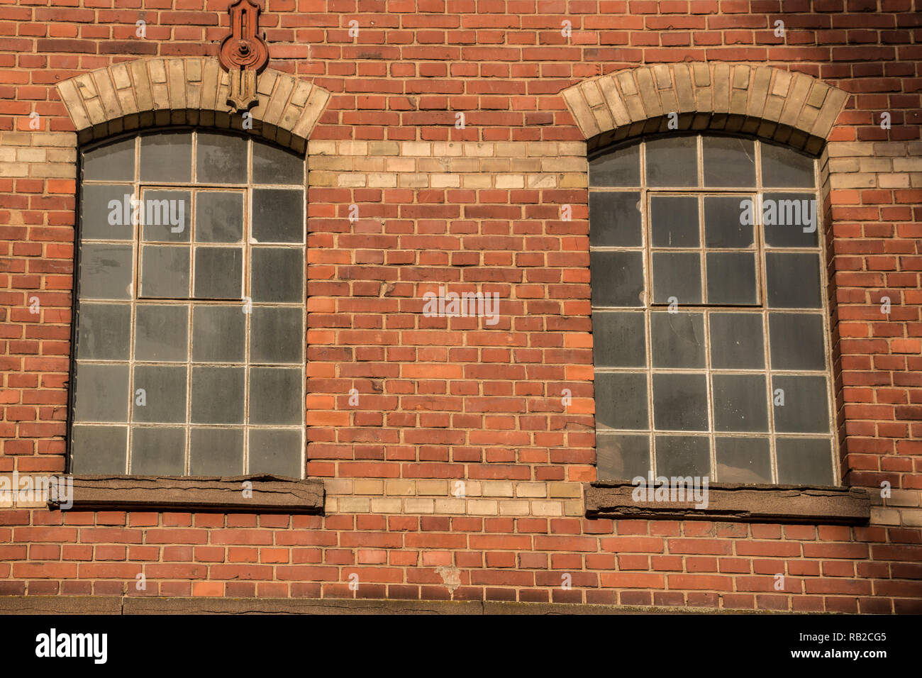 Old empty brick house factory with dark windows Stock Photo